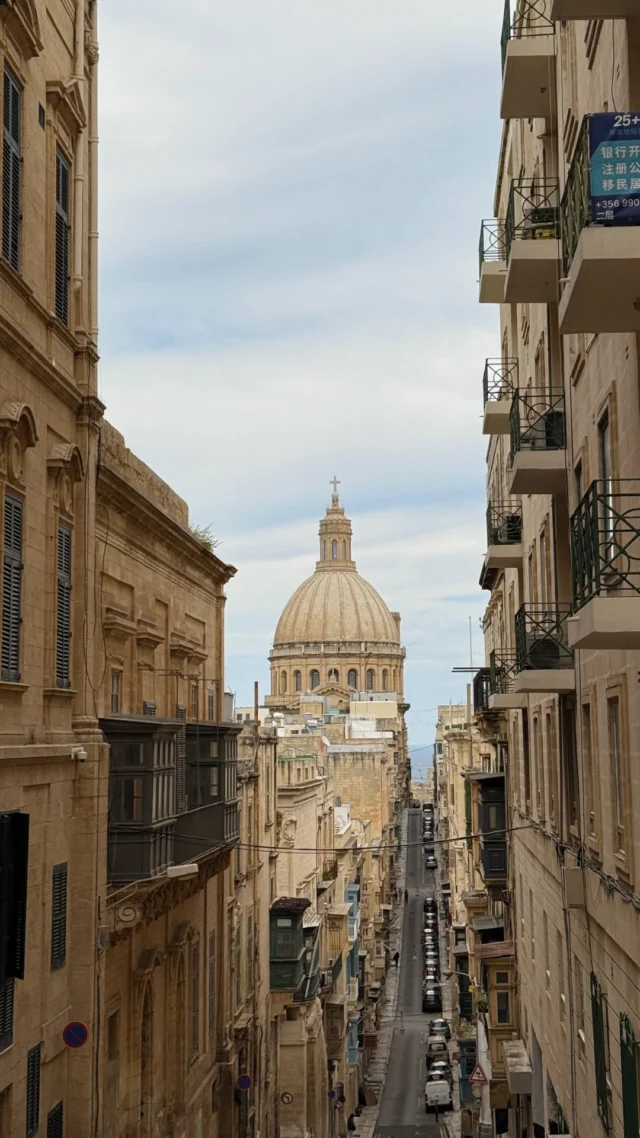 If you’re visiting Malta, this is a beautiful spot to capture the dome of the Basilica of Our Lady of Mount Carmel in Valletta, right at the corner of Old Mint Street and St. Ursula Street in Valletta. 📸📍Tap the link in our bio to grab your  Malta Travel Guide and start planning your trip!